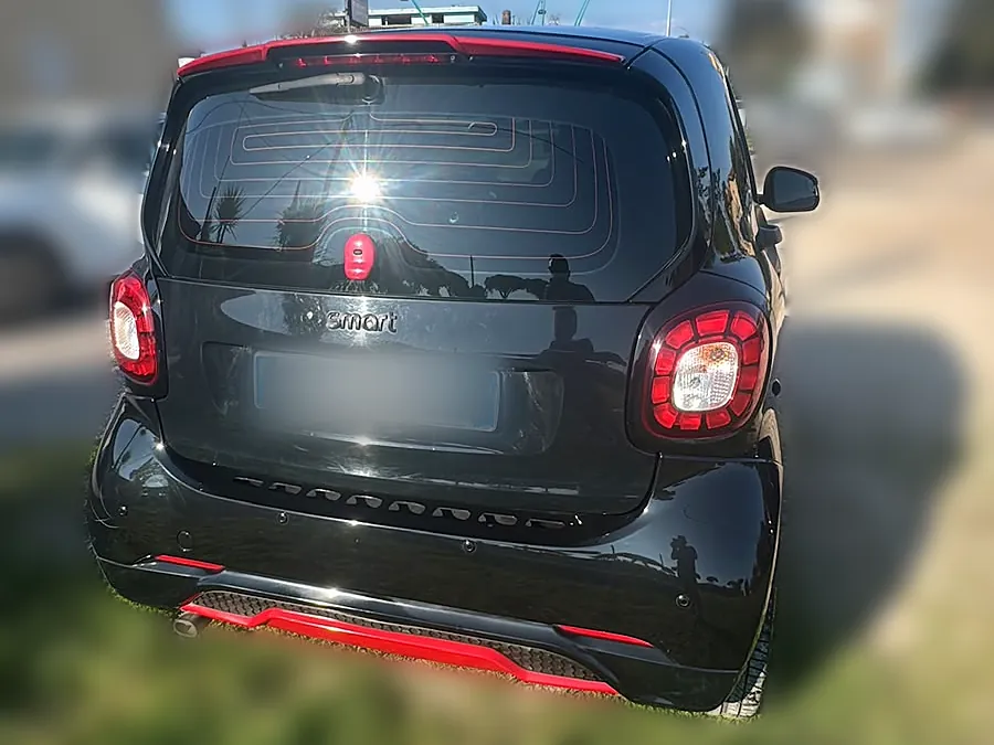 Smart fortwo Brabus nera vista da dietro, con il diffusore rosso, noleggio a Latina
